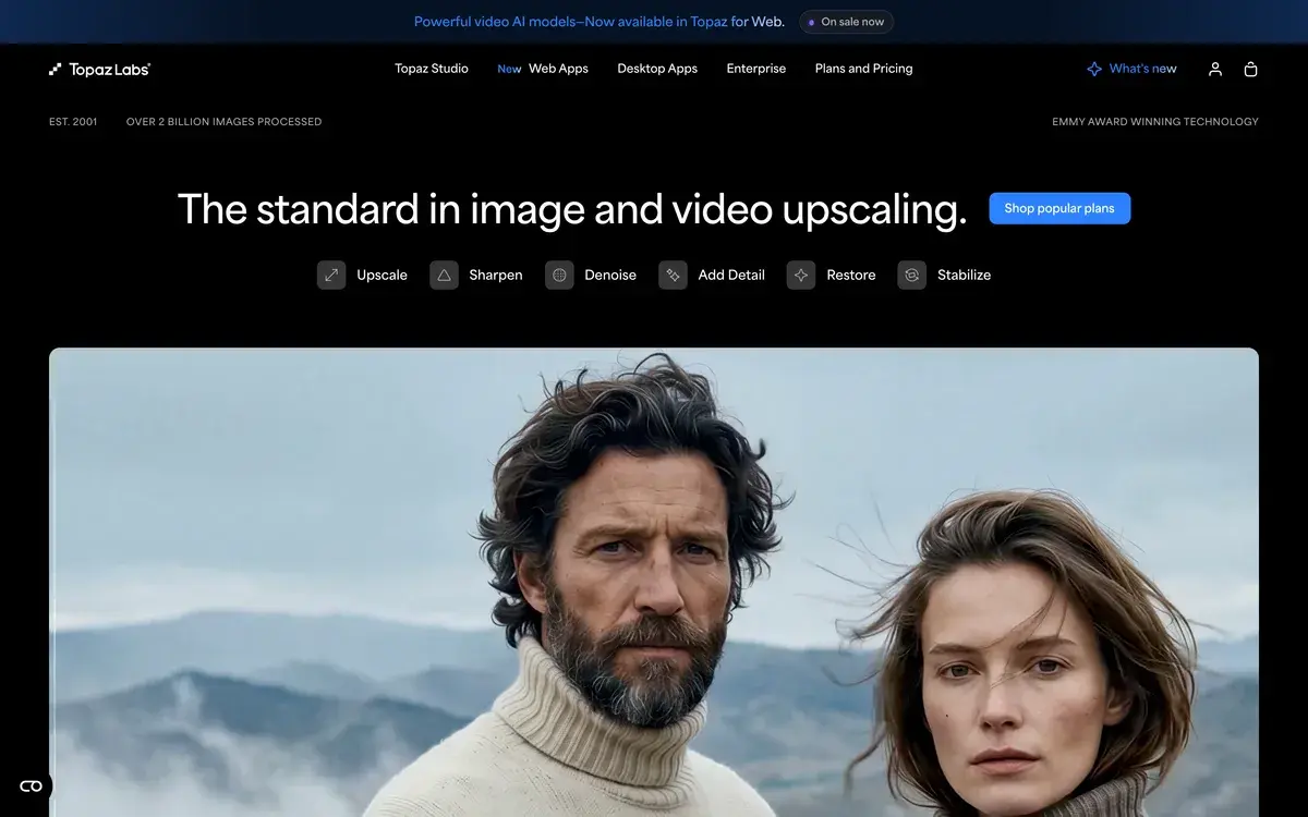 Topaz Labs homepage in September 2026 with a banner saying powerful video AI models are now available in Topaz for Web, the headline The standard in image and video upscaling, buttons for upscale, sharpen, denoise, add detail, restore and stabilize, and a sharp portrait of two people against mountains